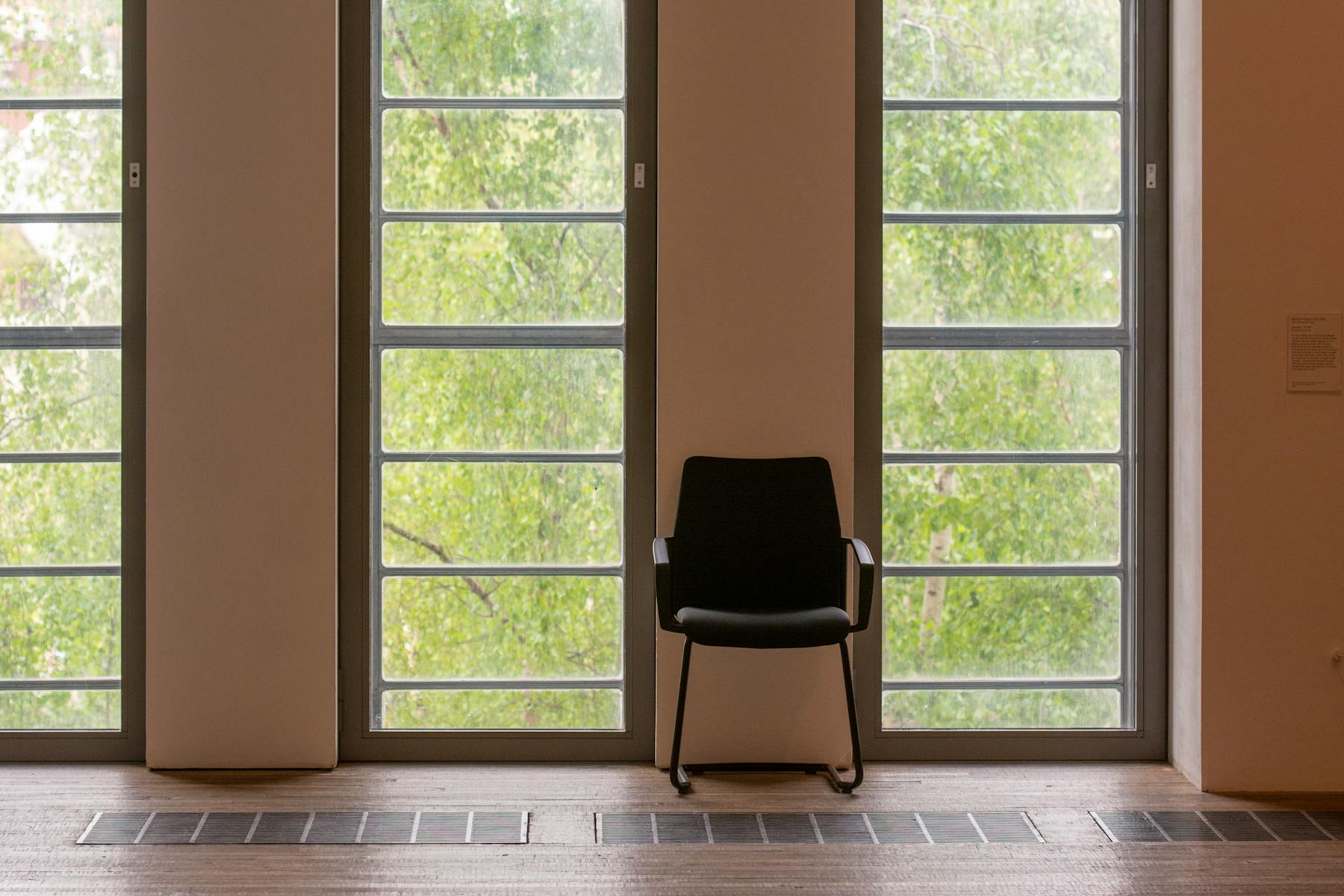 A quiet, sunlit room with a single chair by a tall window — the kind of space we keep for sessions.