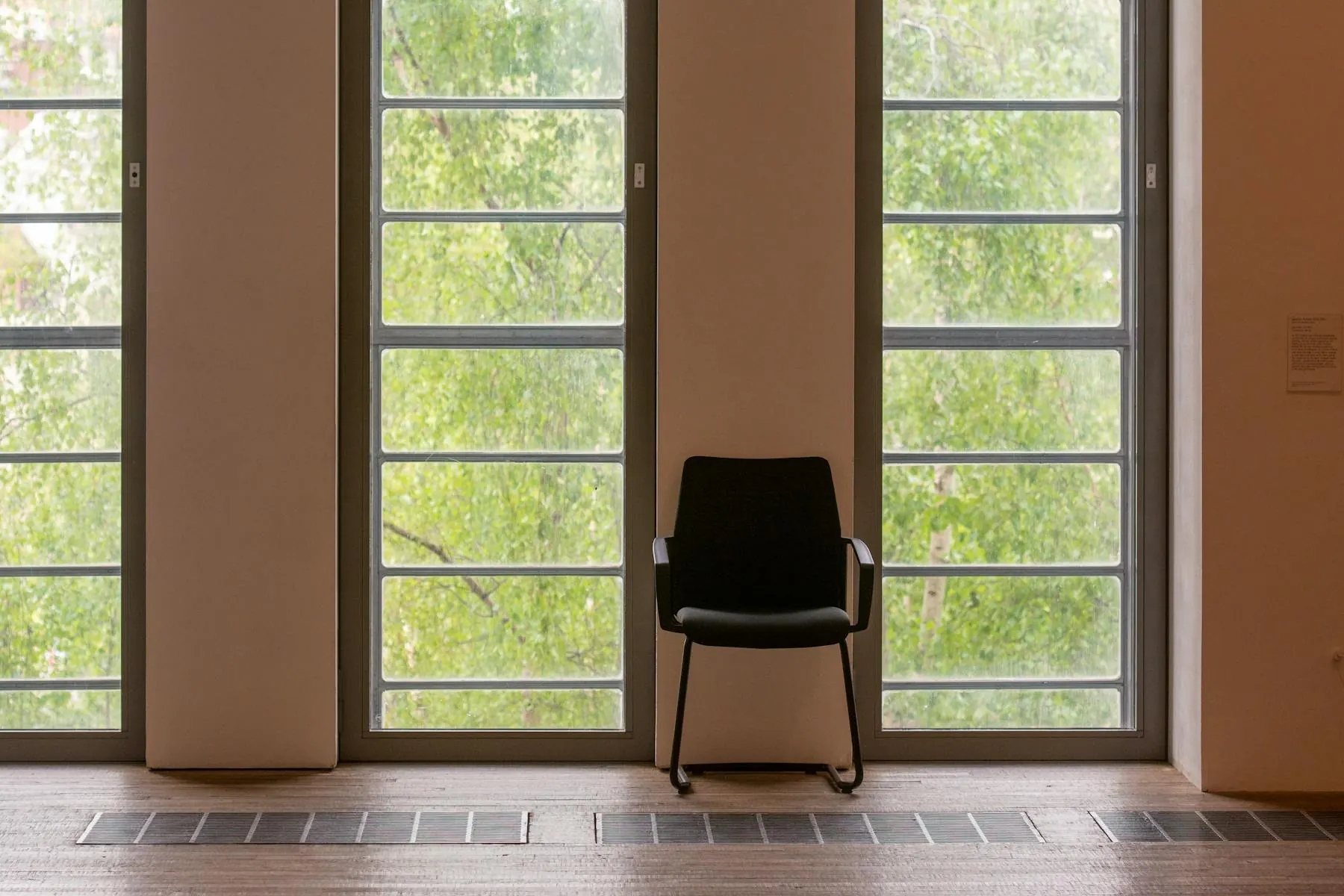 A quiet, sunlit room with a single chair by a tall window — the kind of space we keep for sessions.